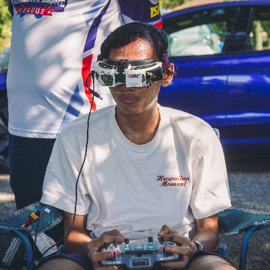 FPV pilot Imad with goggles on and radio in hand